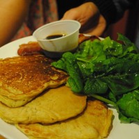 steel cut oat pancakes with stout syrup and apple compote with fresh spinach